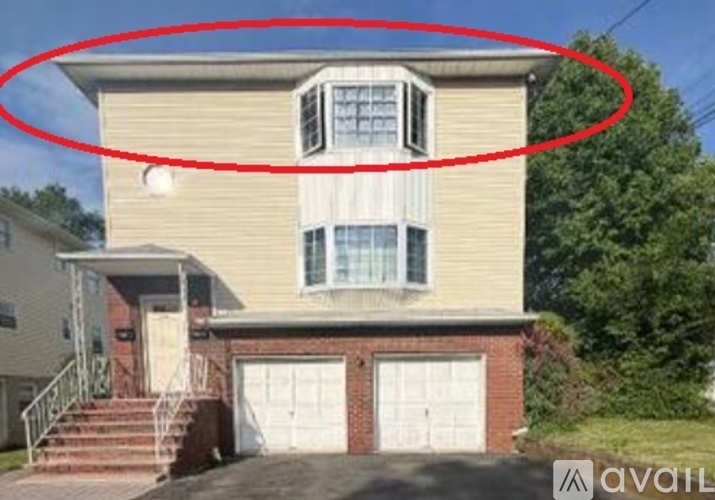 A two-story house with a garage is circled in red.