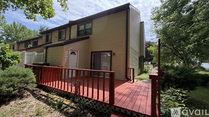 A house with a brown exterior and a red deck.