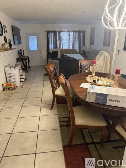 A dining room with a wooden table and chairs.