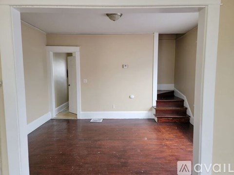 A room with wooden floors and white walls.