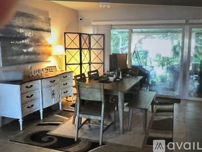 A dining room with a wooden table and chairs.