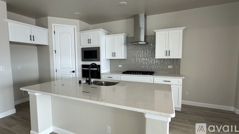 A kitchen with white cabinets and a countertop.