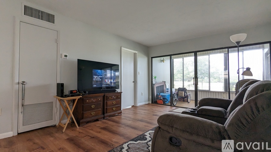 A living room with a television and a couch.