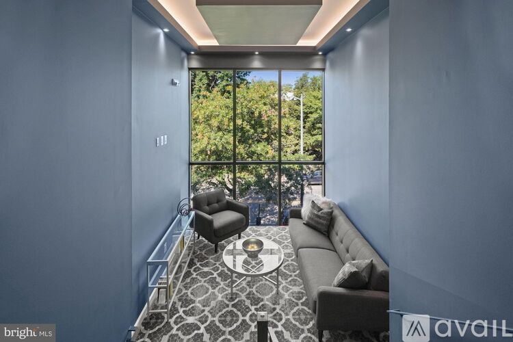 A living room with a grey couch and a round coffee table.