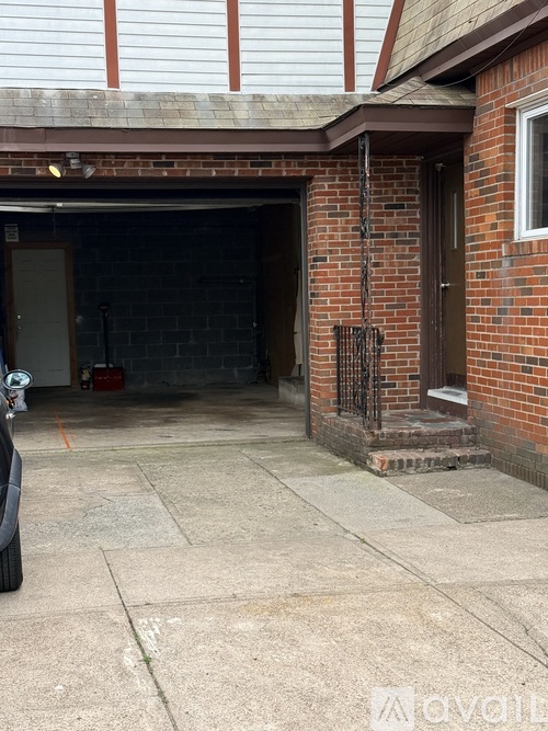 A car is parked in front of a garage.
