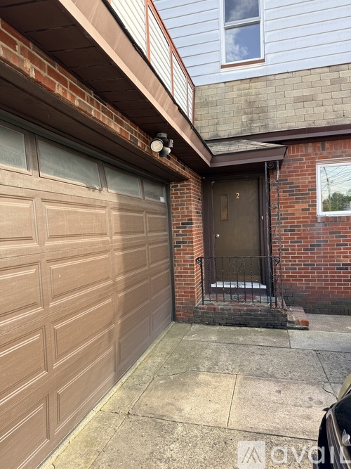 A brown garage door is closed.