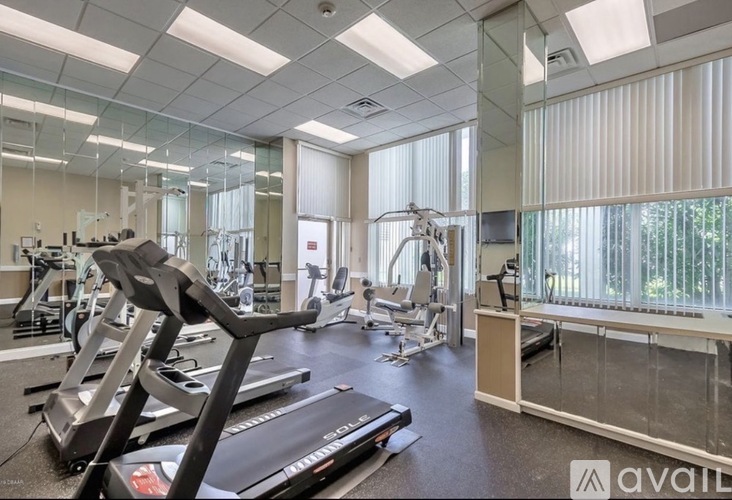 A gym with treadmills, exercise bikes, and other equipment.