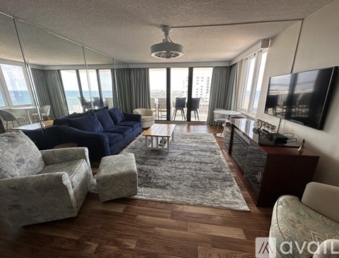 A living room with a large couch and a flat screen TV.