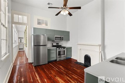 A kitchen with a stainless steel refrigerator, microwave, oven, and sink.