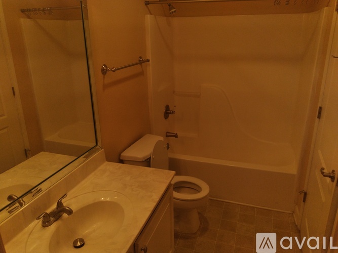 A bathroom with a toilet, sink, and shower.