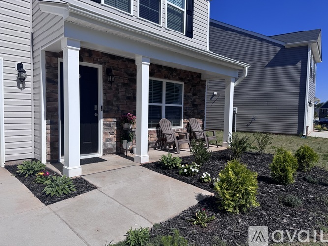A house with a front porch and a black door.