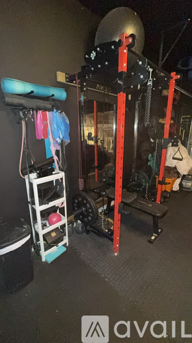 A gym with a variety of equipment including a leg press machine.