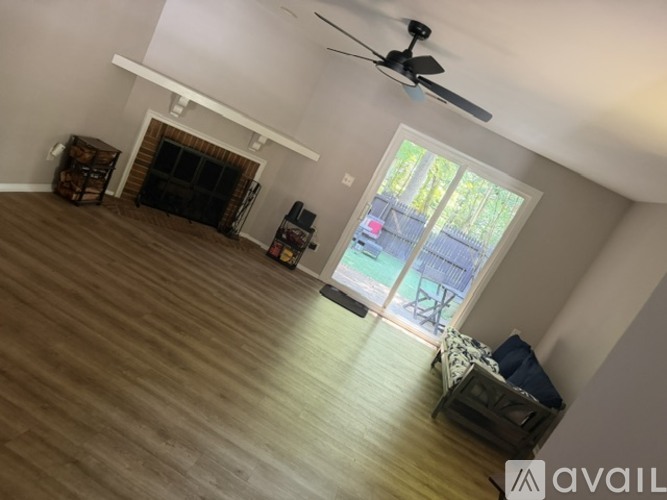 A living room with a fireplace and sliding glass doors.