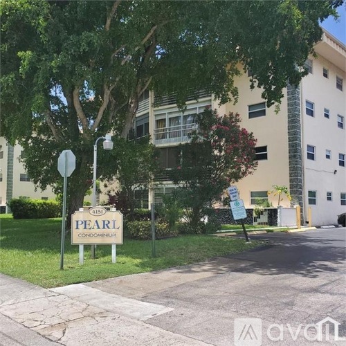 A street view of a building named Pearl Condominiums.