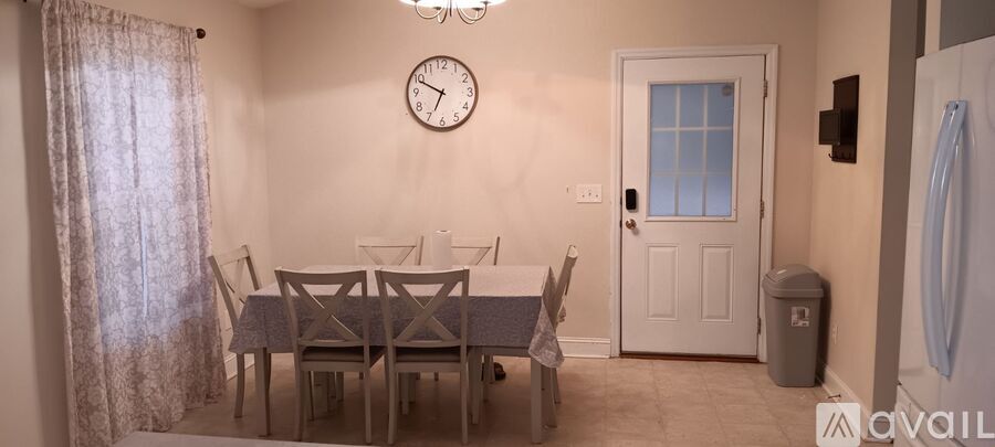 A dining room with a table set for six.
