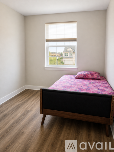A bedroom with a bed and a window.