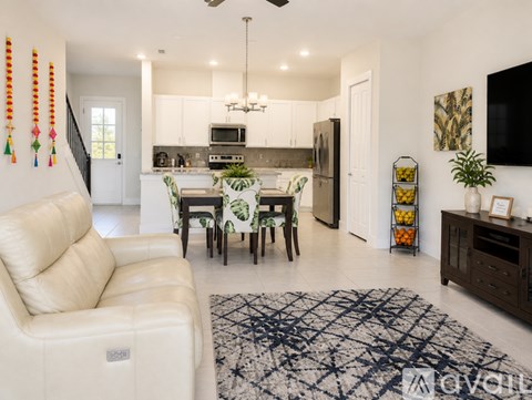 A modern kitchen with a dining table set for four.