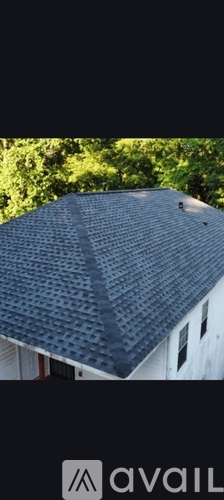 A roof with dark grey tiles.