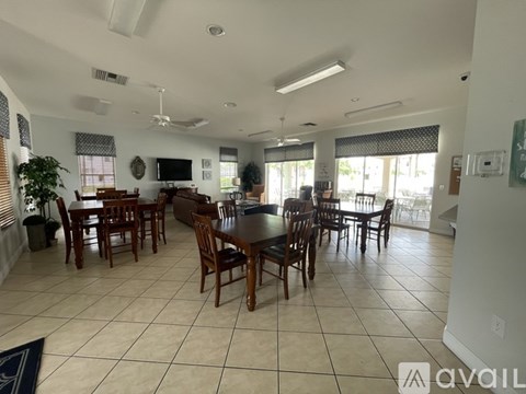 A dining room with a table set for six.