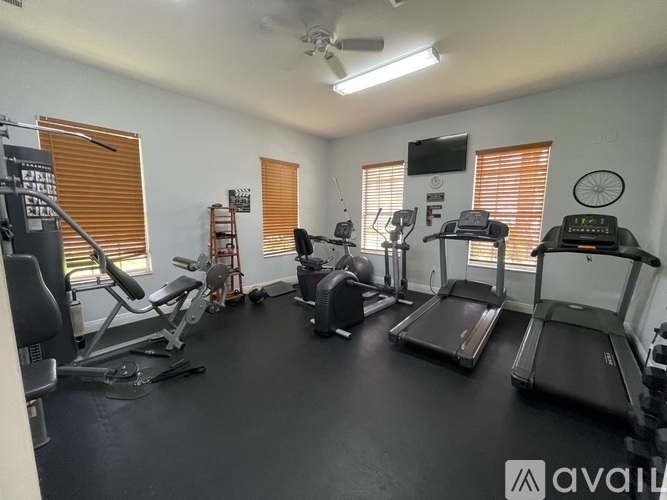 A gym with treadmills, exercise bikes, and other equipment.
