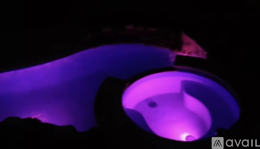 A purple light illuminates a dark background.
