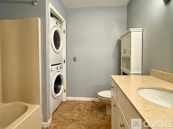 A small laundry room with a washer and dryer.