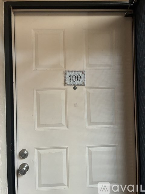 A white door with a black frame and a number 100 on it.