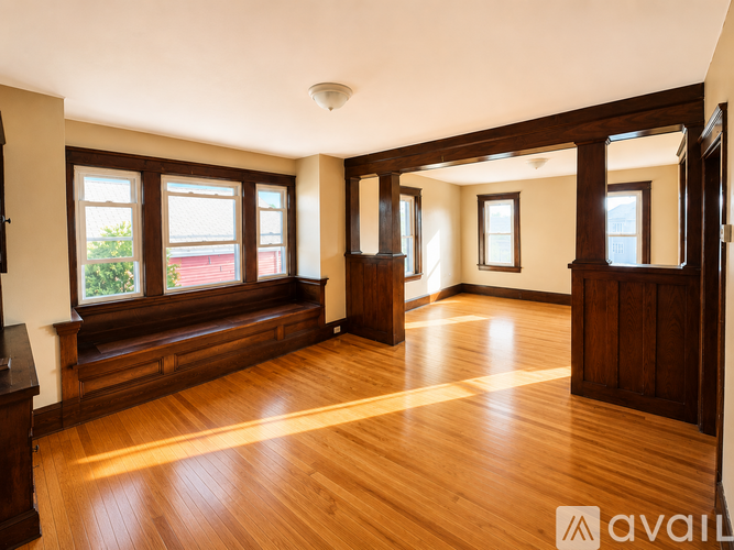A room with wooden floors and a large window.