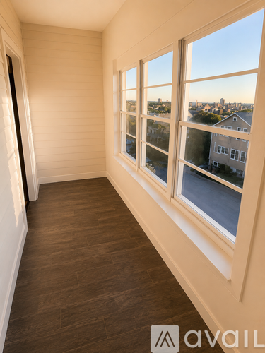 A room with a window overlooking a cityscape.