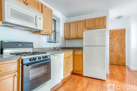 A kitchen with wooden cabinets and a white refrigerator.
