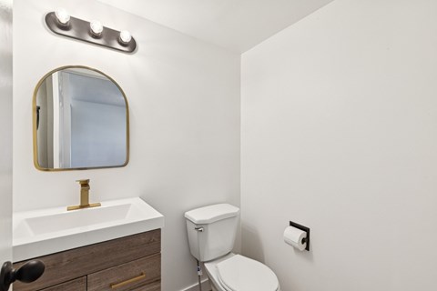 A white toilet sits next to a sink in a bathroom.