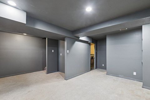A spacious room with grey walls and carpeted floor.