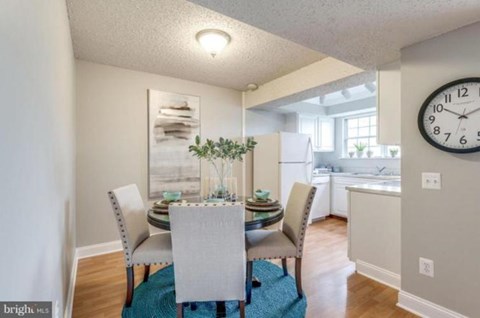 A dining room with a table set for four.