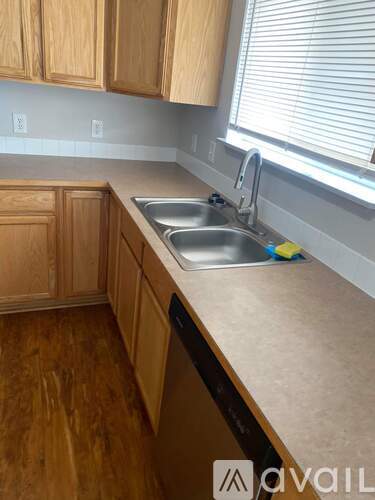 A kitchen with wooden cabinets and a sink.