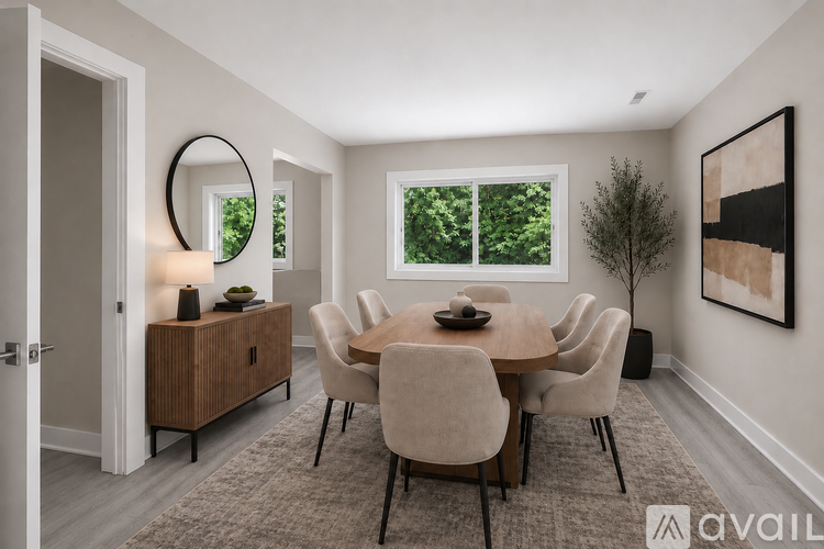 A modern dining room with a round table and chairs.