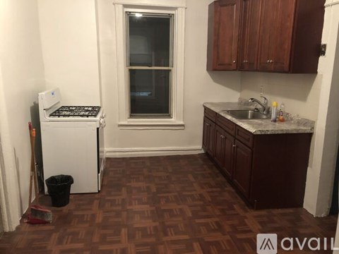 A kitchen with brown tiled floors and white appliances.