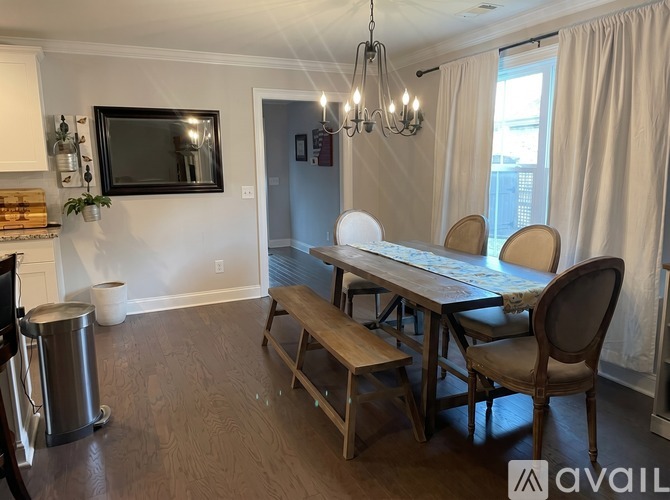 A dining room with a wooden table and chairs.