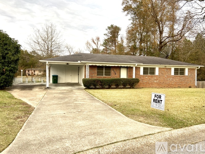 A house with a "For Rent" sign in front.