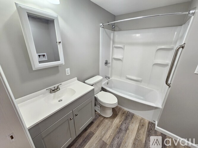 A bathroom with a white sink, toilet, and bathtub.