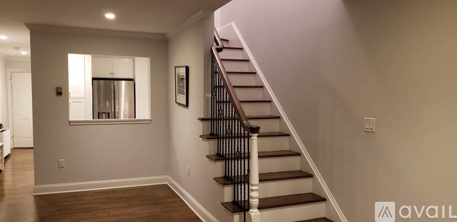 A staircase with a black railing and wooden steps.