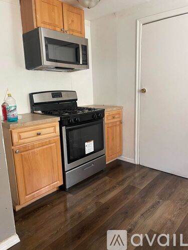 A kitchen with a stove top oven and microwave.