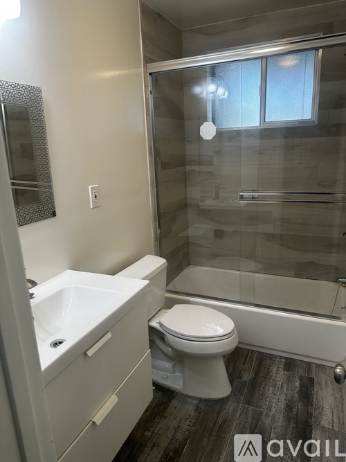 A bathroom with a toilet, sink, and tub.