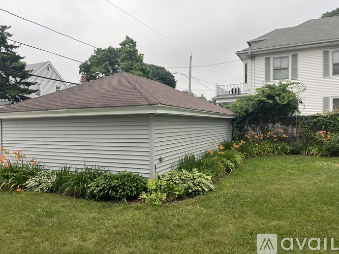A house with a brown roof and a well-maintained lawn.
