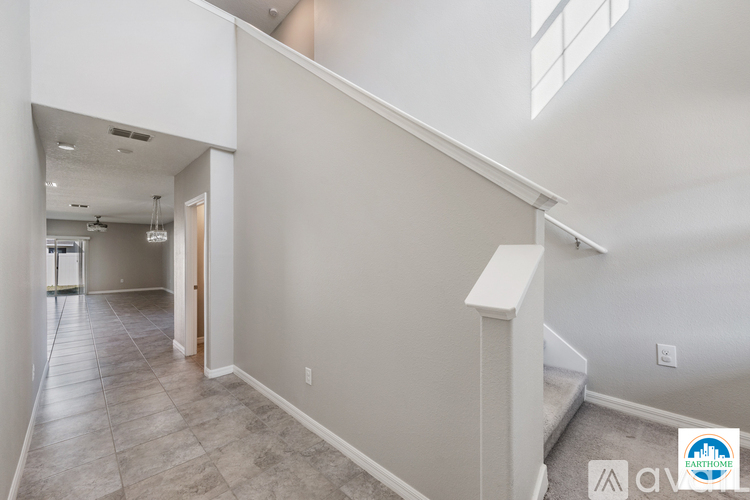 A spacious hallway with a staircase leading to the second floor.