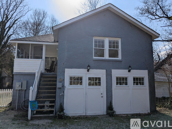 A two-story house with a garage and a white door.