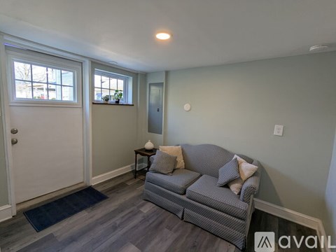 A living room with a grey couch and a small table.