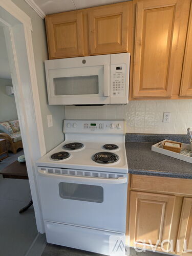 A white stove and microwave in a kitchen.