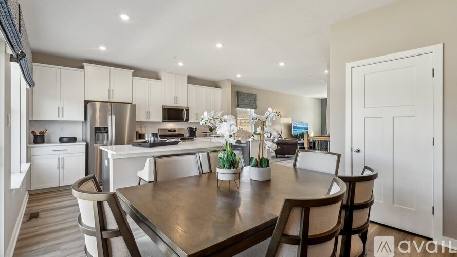 A kitchen with a table and chairs in the middle of it.