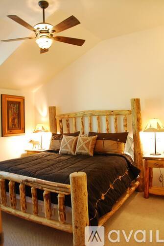 A bedroom with a bed and a ceiling fan.