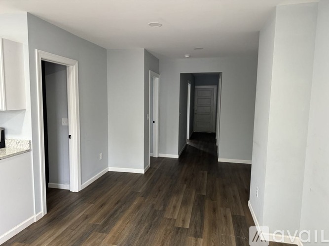 A room with wooden floors and white walls.